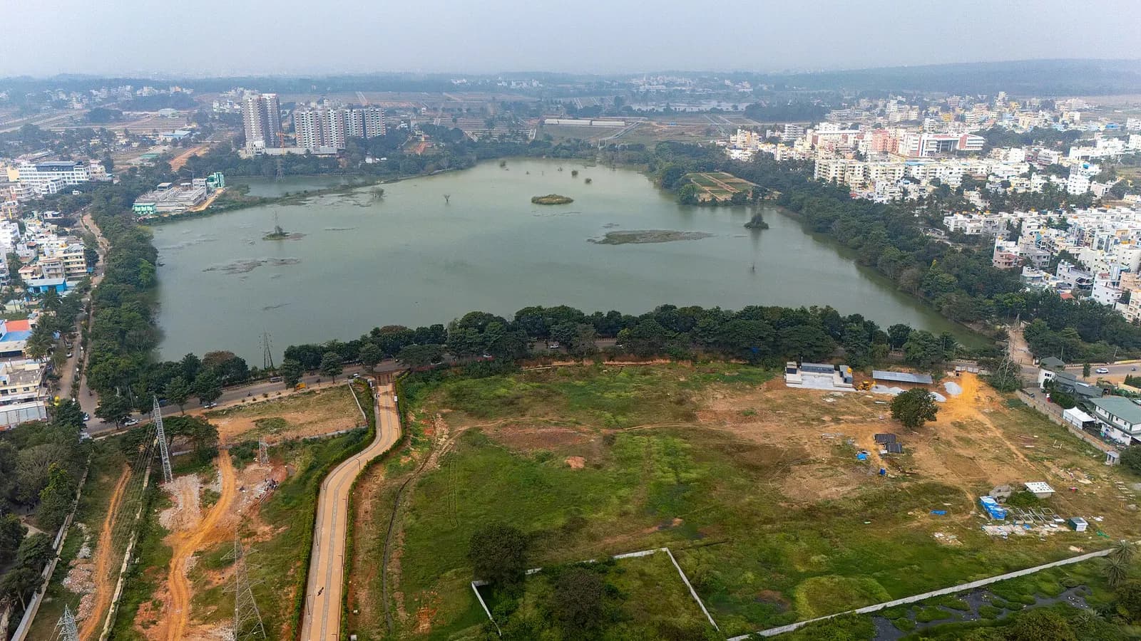 Aerial view of an urban lake with housing and roads along its edges